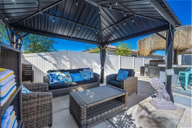 view of patio / terrace with outdoor lounge area, grilling area, an outdoor kitchen, and a gazebo