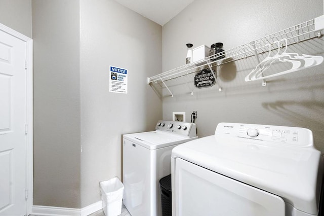 clothes washing area with washing machine and dryer