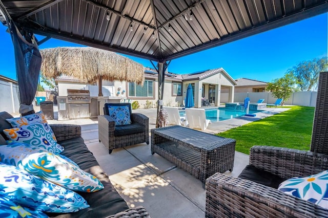 view of patio with an outdoor hangout area, area for grilling, and a fenced in pool