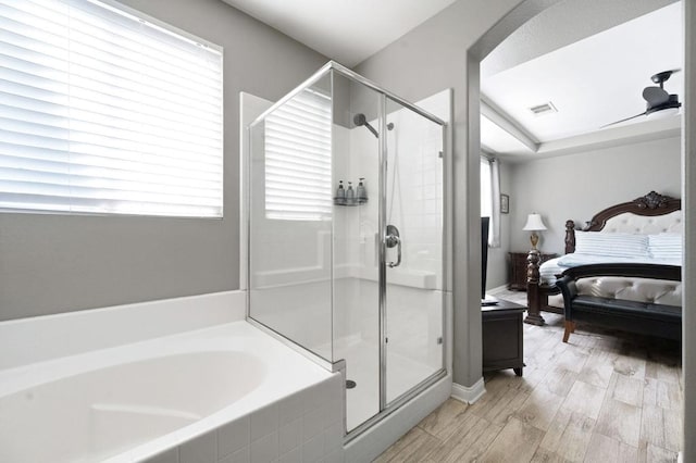 bathroom featuring separate shower and tub, plenty of natural light, and hardwood / wood-style flooring