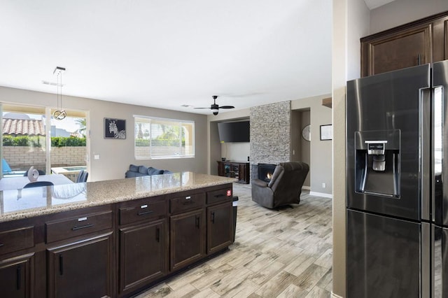 kitchen featuring light wood-type flooring, dark brown cabinets, ceiling fan, decorative light fixtures, and stainless steel fridge with ice dispenser