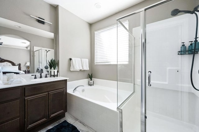 bathroom featuring vanity and separate shower and tub