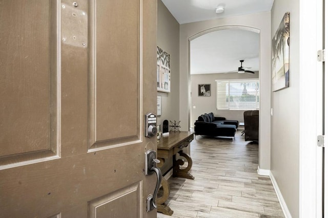 corridor with light hardwood / wood-style flooring