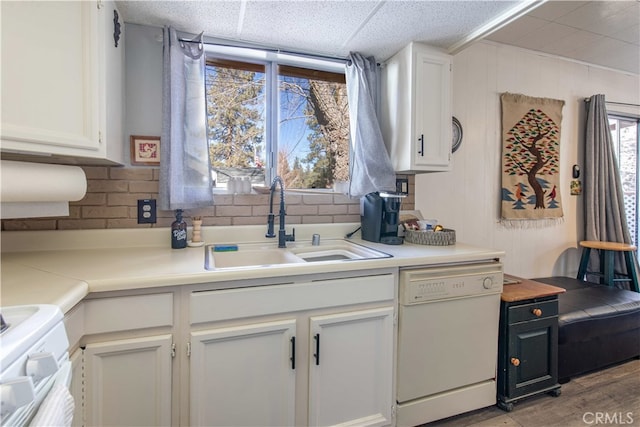 kitchen with white appliances, sink, and white cabinets