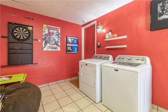 laundry area with light tile patterned flooring and washer and dryer