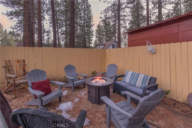 patio terrace at dusk featuring an outdoor fire pit