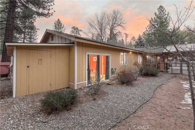 rear view of property with a gate and fence