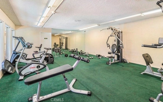 exercise room with a textured ceiling