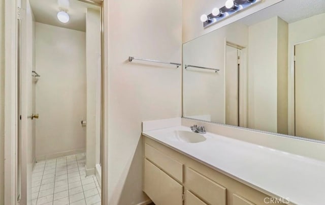 bathroom with tile patterned flooring and vanity