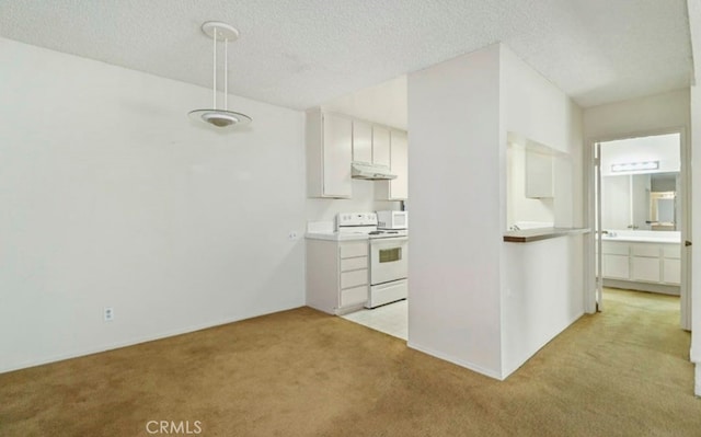 kitchen featuring a textured ceiling, white cabinetry, light carpet, and electric range