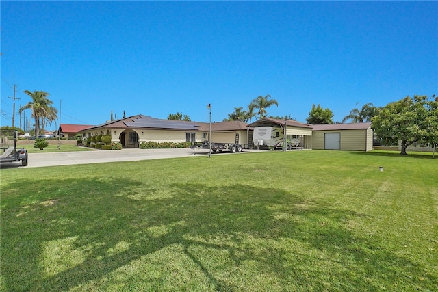 view of front of property featuring an outdoor structure and a front lawn