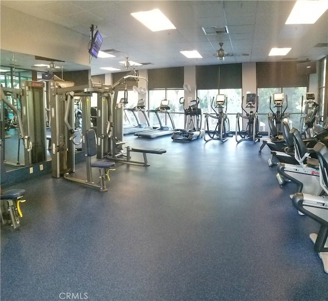 workout area with ceiling fan and a drop ceiling