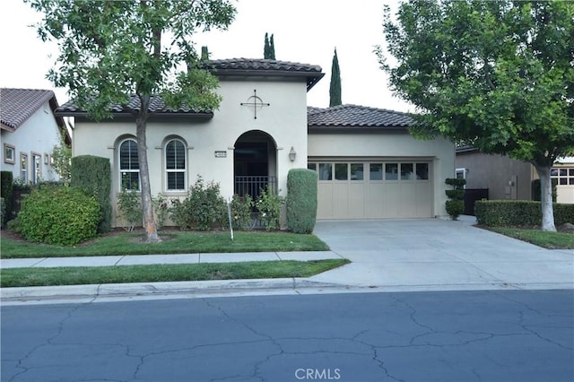 mediterranean / spanish home featuring a garage