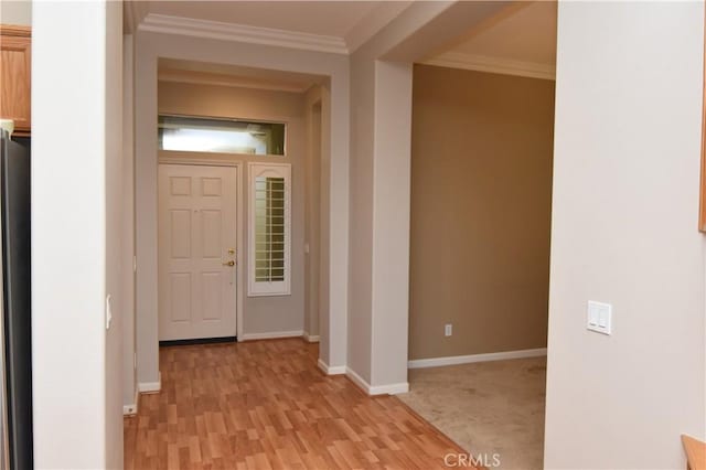 interior space with light hardwood / wood-style flooring and crown molding