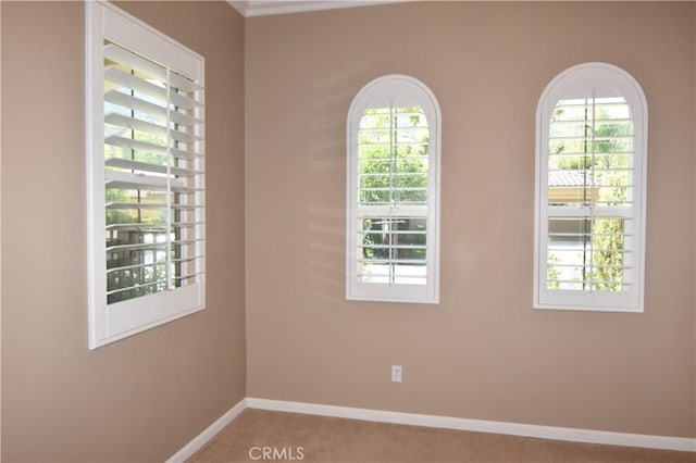 empty room with light carpet and a healthy amount of sunlight