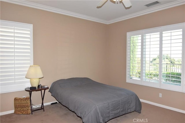 bedroom with carpet floors, crown molding, and ceiling fan