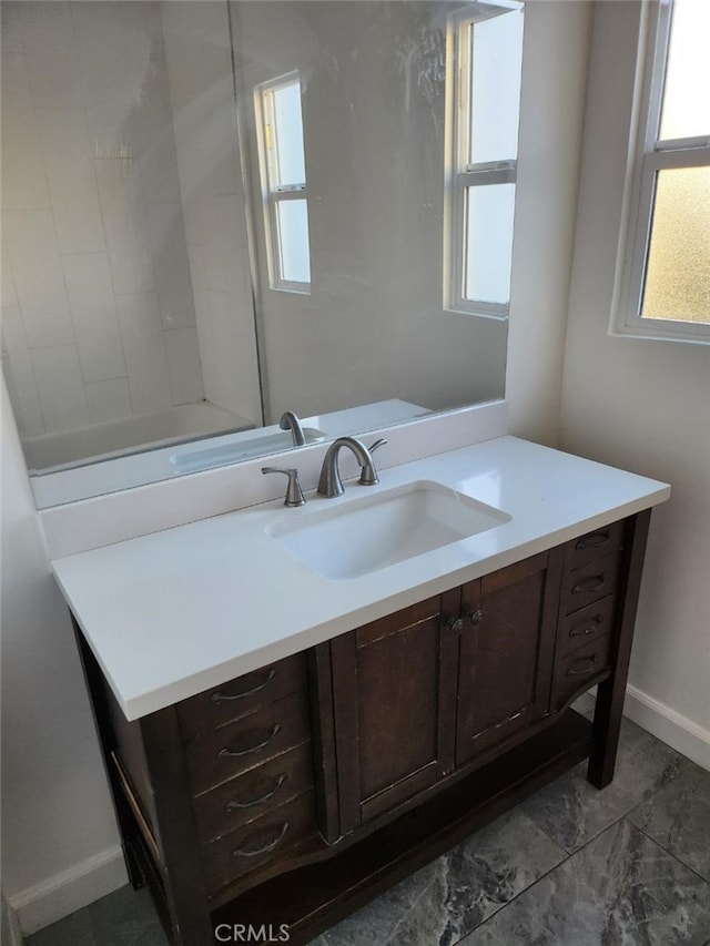 bathroom with vanity and a wealth of natural light