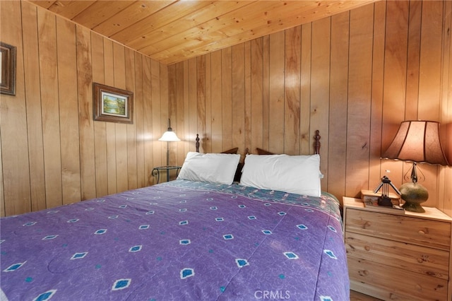 bedroom featuring wood walls and wooden ceiling