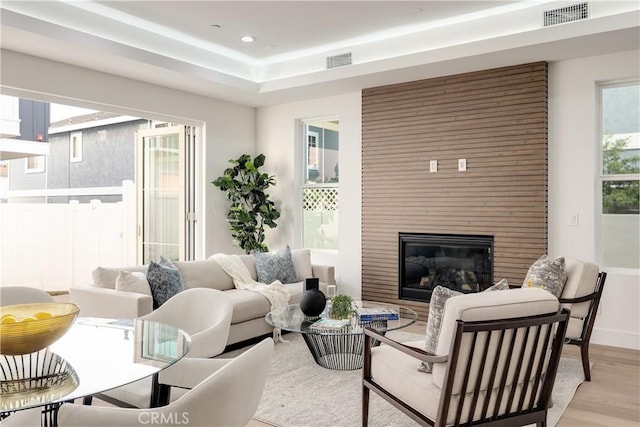 living room with light hardwood / wood-style floors and a fireplace