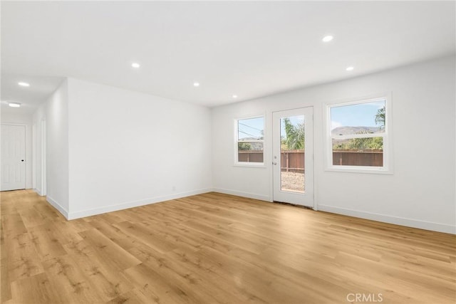 spare room featuring light hardwood / wood-style floors