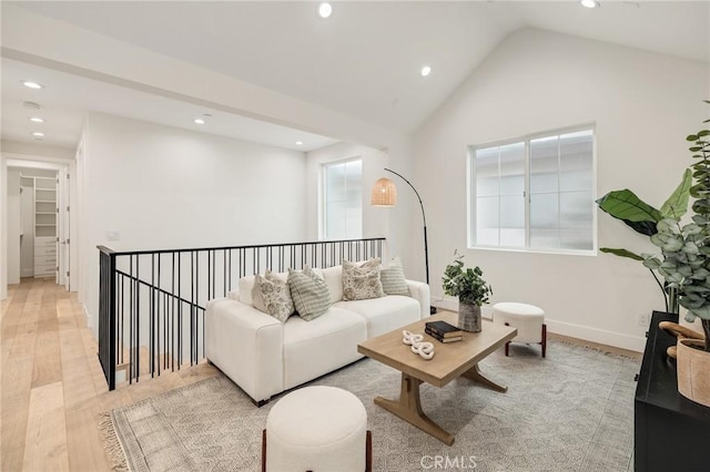 living area with vaulted ceiling, light wood-type flooring, baseboards, and recessed lighting