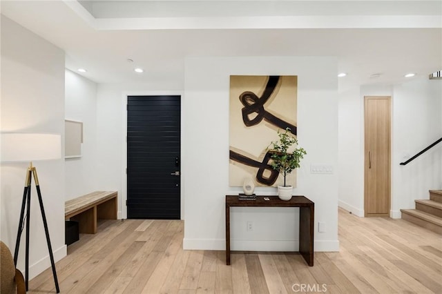 interior space featuring recessed lighting, baseboards, stairway, and hardwood / wood-style floors