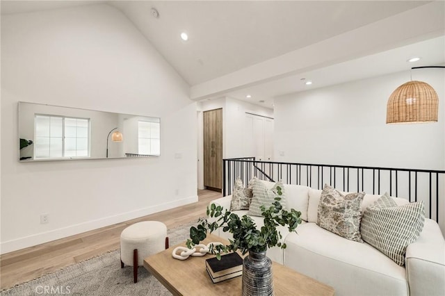 living room featuring high vaulted ceiling, recessed lighting, light wood-type flooring, and baseboards