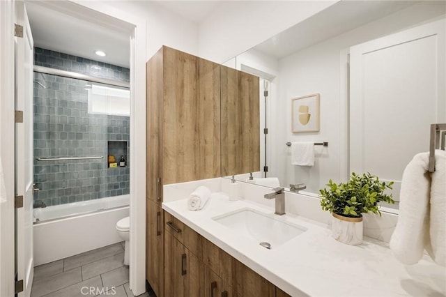 bathroom featuring toilet, vanity, bathtub / shower combination, and tile patterned floors