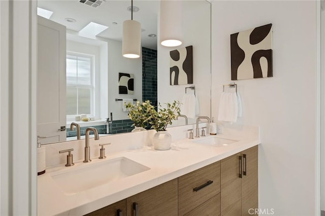 full bathroom featuring double vanity, a sink, and visible vents