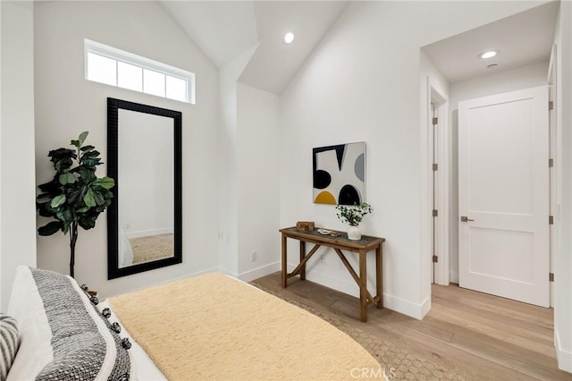 bedroom featuring light wood-type flooring, recessed lighting, baseboards, and lofted ceiling