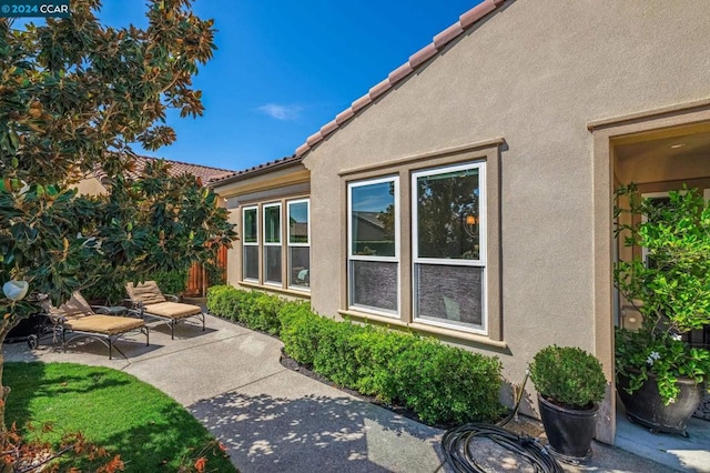 view of side of property featuring a patio