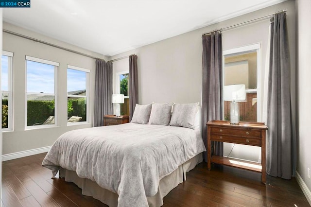 bedroom with dark wood-type flooring