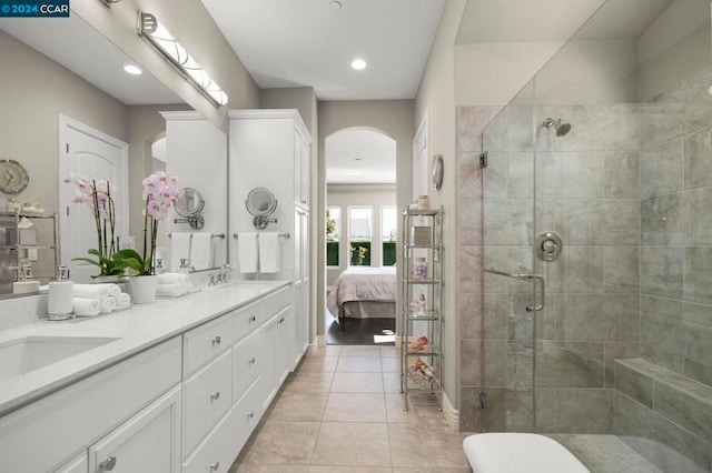 bathroom featuring vanity, walk in shower, and tile patterned floors