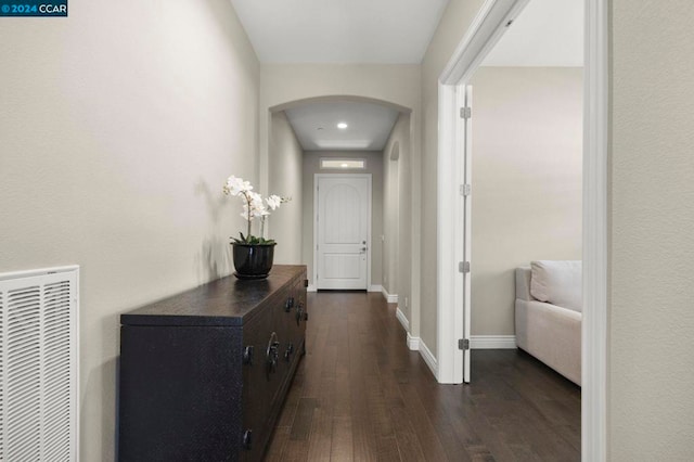 hallway with dark hardwood / wood-style flooring