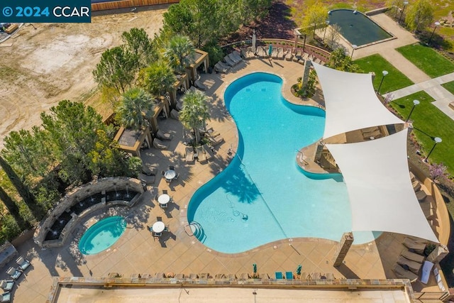 view of swimming pool featuring a community hot tub and a patio area