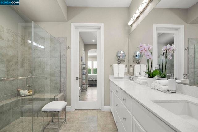 bathroom featuring vanity, tile patterned floors, and an enclosed shower