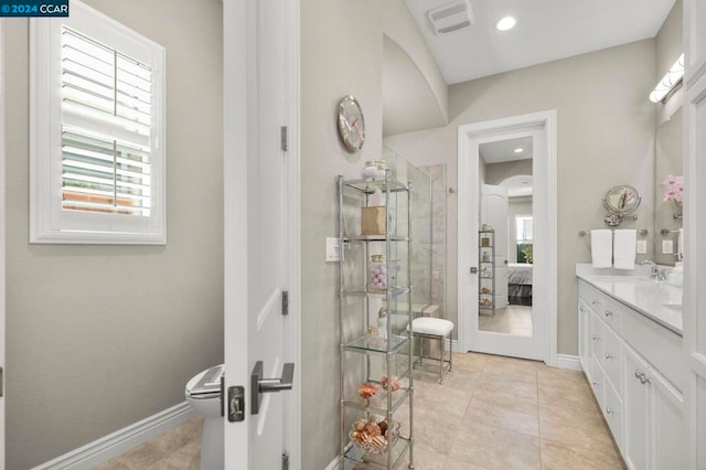 bathroom featuring vanity, toilet, tile patterned floors, and plenty of natural light