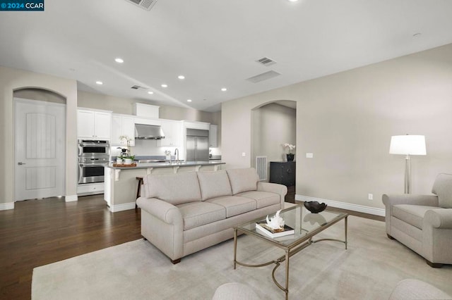 living room with sink and light wood-type flooring