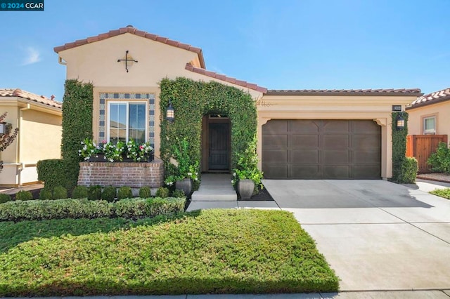 mediterranean / spanish house featuring a garage