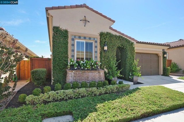 mediterranean / spanish house with a garage