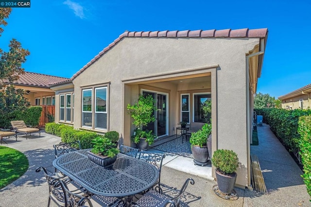 back of property featuring a patio area