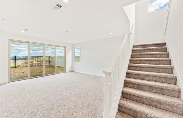 stairway featuring recessed lighting, carpet, visible vents, and baseboards