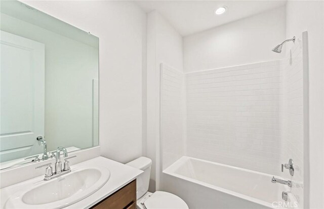 full bathroom featuring recessed lighting, washtub / shower combination, toilet, and vanity