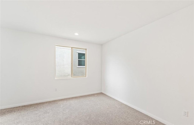 carpeted spare room with recessed lighting and baseboards