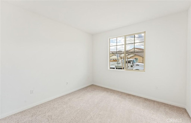 spare room with carpet flooring and baseboards