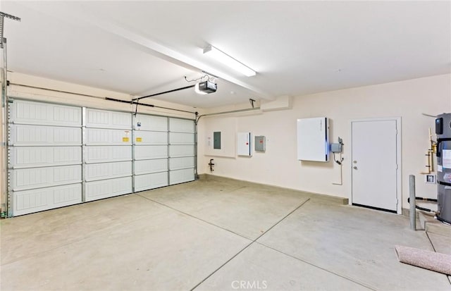 garage with electric panel and a garage door opener