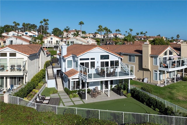 rear view of house with a balcony and a patio