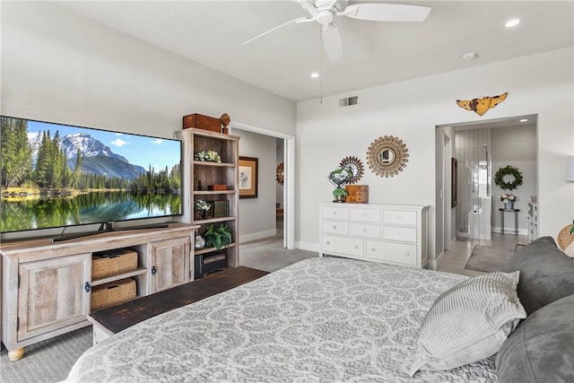 bedroom with carpet flooring, ensuite bathroom, and ceiling fan