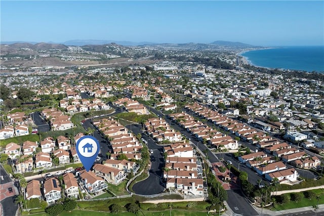 drone / aerial view with a water and mountain view