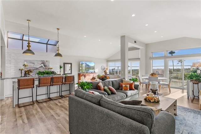 living room with light hardwood / wood-style floors and lofted ceiling